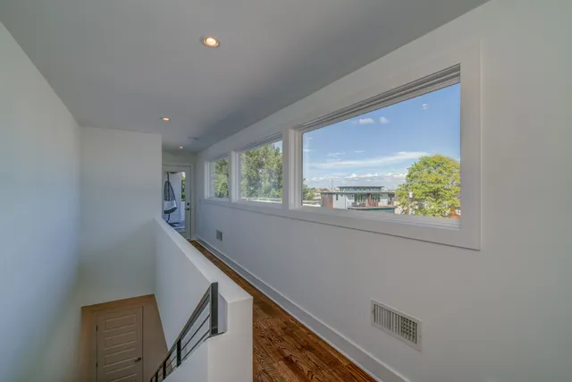 a view of an entryway with wooden floor