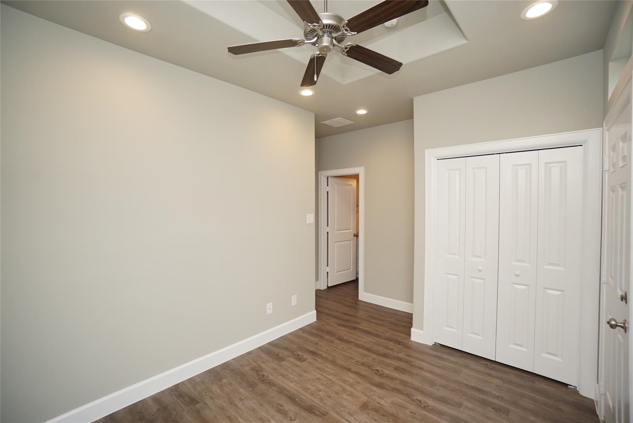 1137 4th Street Rosenberg, TX 77471 - Photo 8 of 16 an empty room with wooden floor and windows