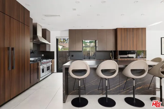 a kitchen with kitchen island granite countertop a sink and a stove