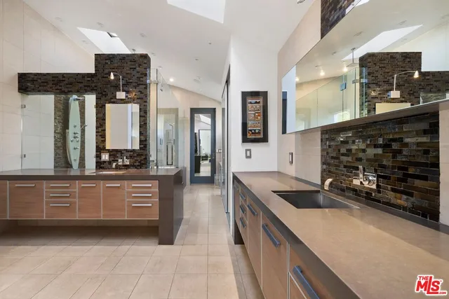 a kitchen with stainless steel appliances granite countertop a sink and cabinets