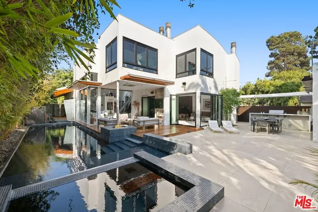 a view of a swimming pool with chairs in patio