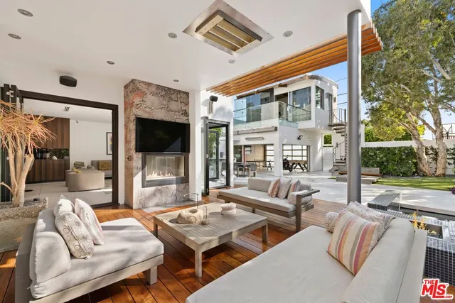 a outdoor space with patio the couches and a flat screen tv