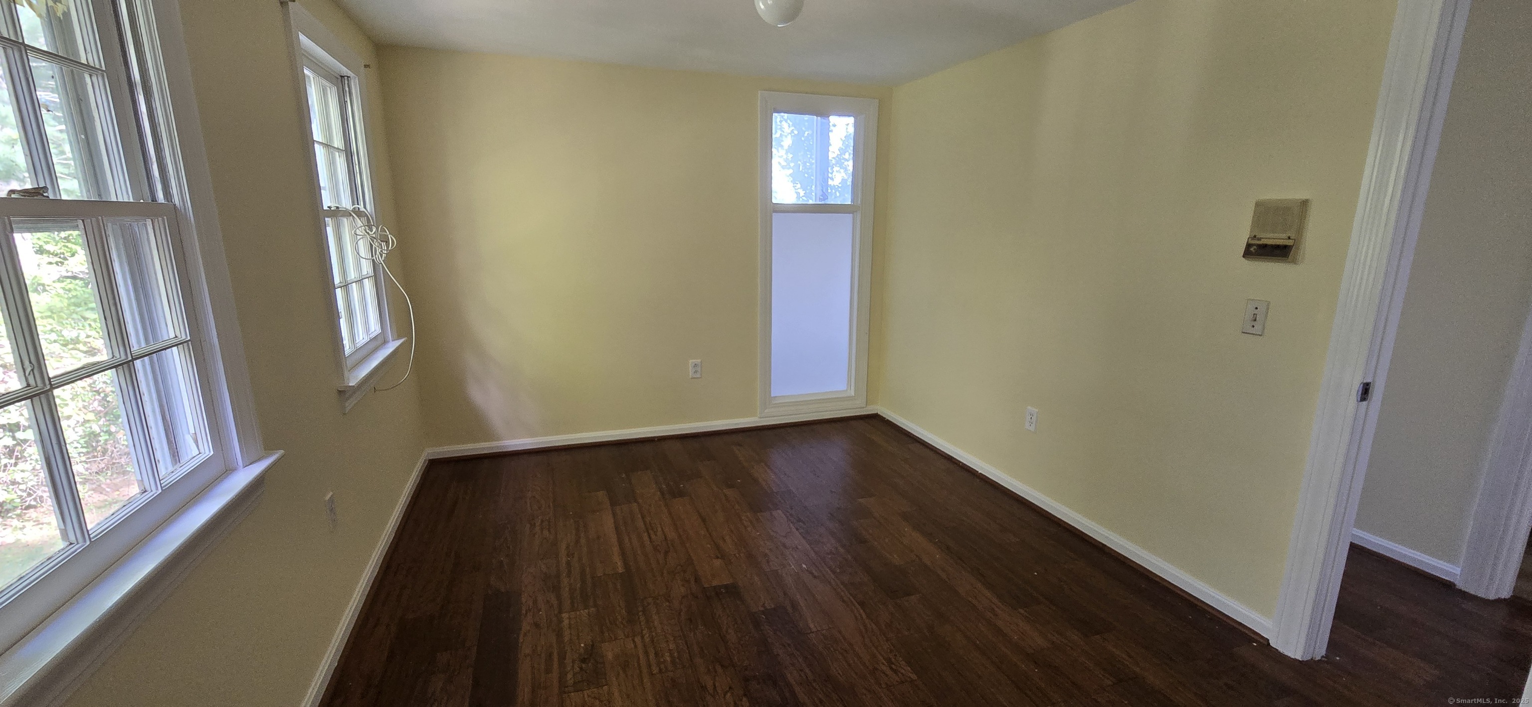 187 West Avon Road Avon, CT 06001 - Photo 12 of 40 a view of an empty room with wooden floor and a window