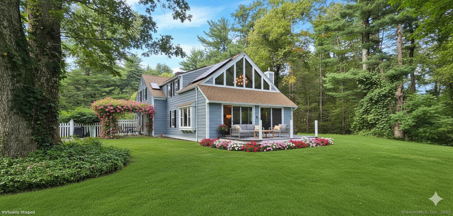 187 West Avon Road Avon, CT 06001 - Photo 25 of 40 a front view of a house with a yard table and chairs