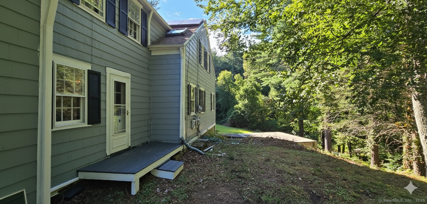 187 West Avon Road Avon, CT 06001 - Photo 26 of 40 a backyard of a house with large trees