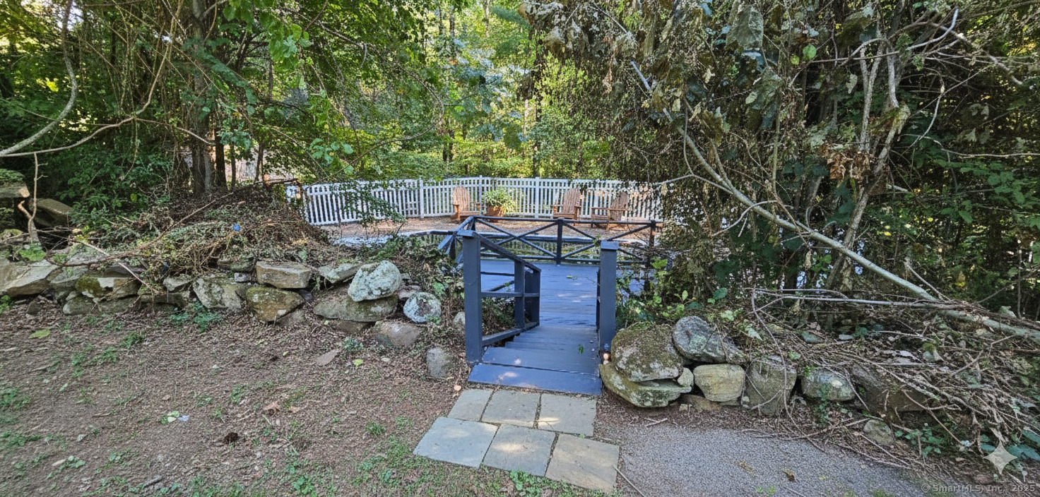 187 West Avon Road Avon, CT 06001 - Photo 29 of 40 a view of a patio with table and chairs potted plants and large tree