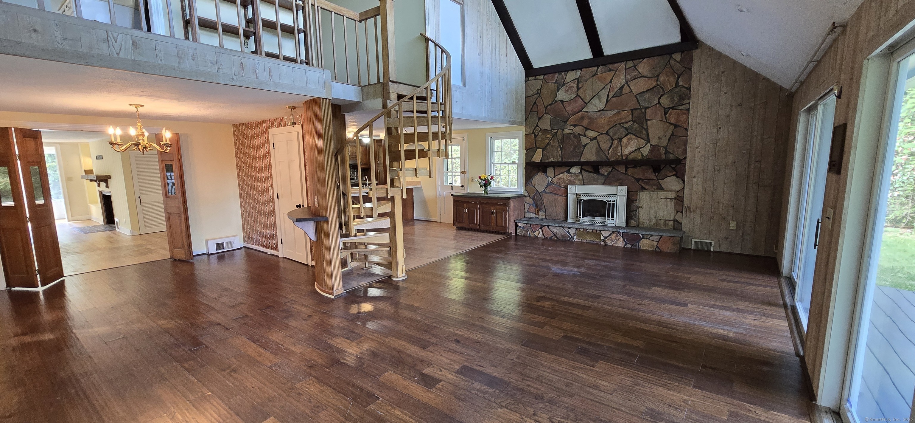 187 West Avon Road Avon, CT 06001 - Photo 5 of 40 a view of empty room with wooden floor and fireplace