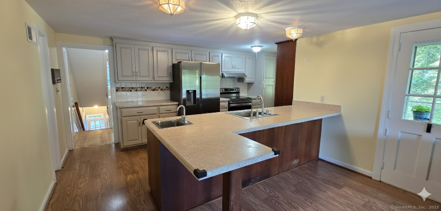 187 West Avon Road Avon, CT 06001 - Photo 7 of 40 a kitchen with stainless steel appliances a sink stove and refrigerator