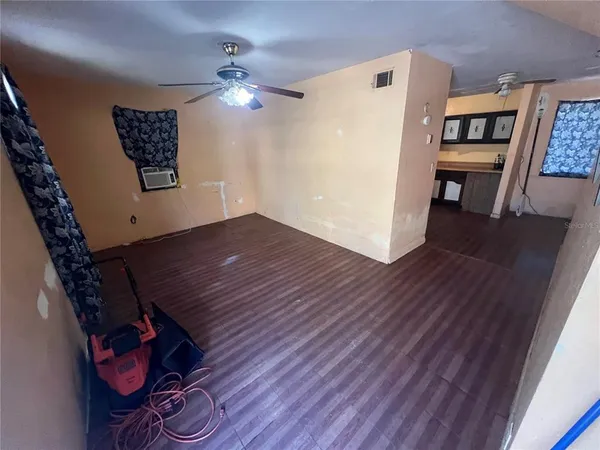 a view of a hallway with wooden floor and workspace