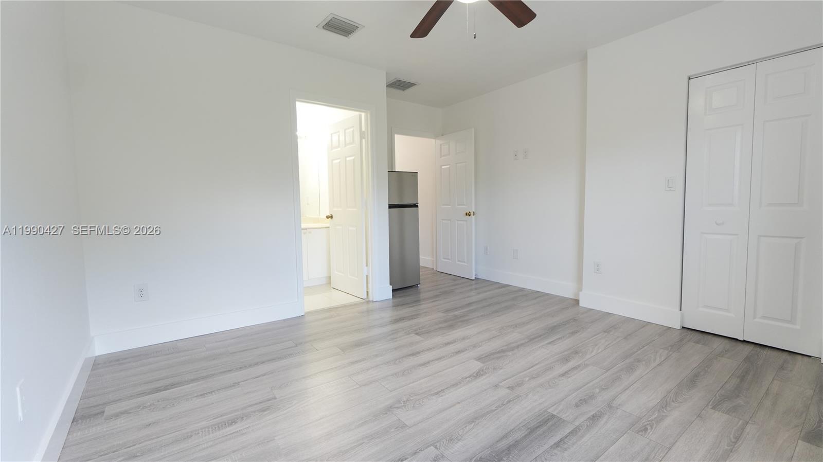 14138 Southwest 260th Street, Unit 106 Homestead, FL 33032 - Photo 1 of 12 wooden floor in an empty room