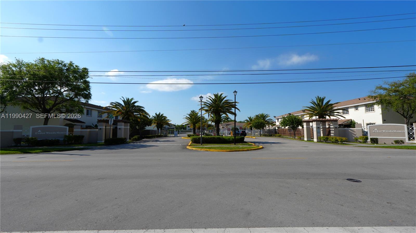 14138 Southwest 260th Street, Unit 106 Homestead, FL 33032 - Photo 11 of 12 a view of a street with cars