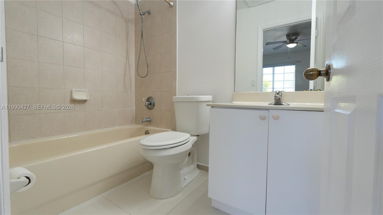 14138 Southwest 260th Street, Unit 106 Homestead, FL 33032 - Photo 3 of 12 a bathroom with a toilet a sink and bathtub