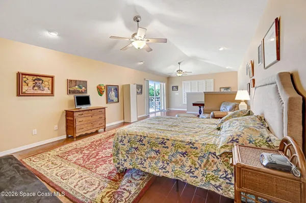 a bed room with a bed mirror and a dresser