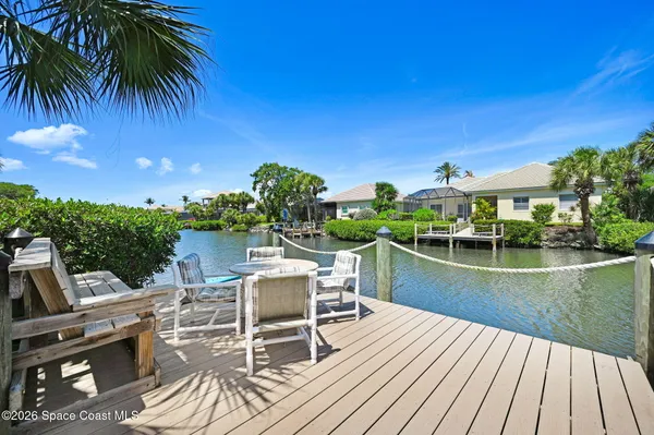 a view of a house with swimming pool and sitting area