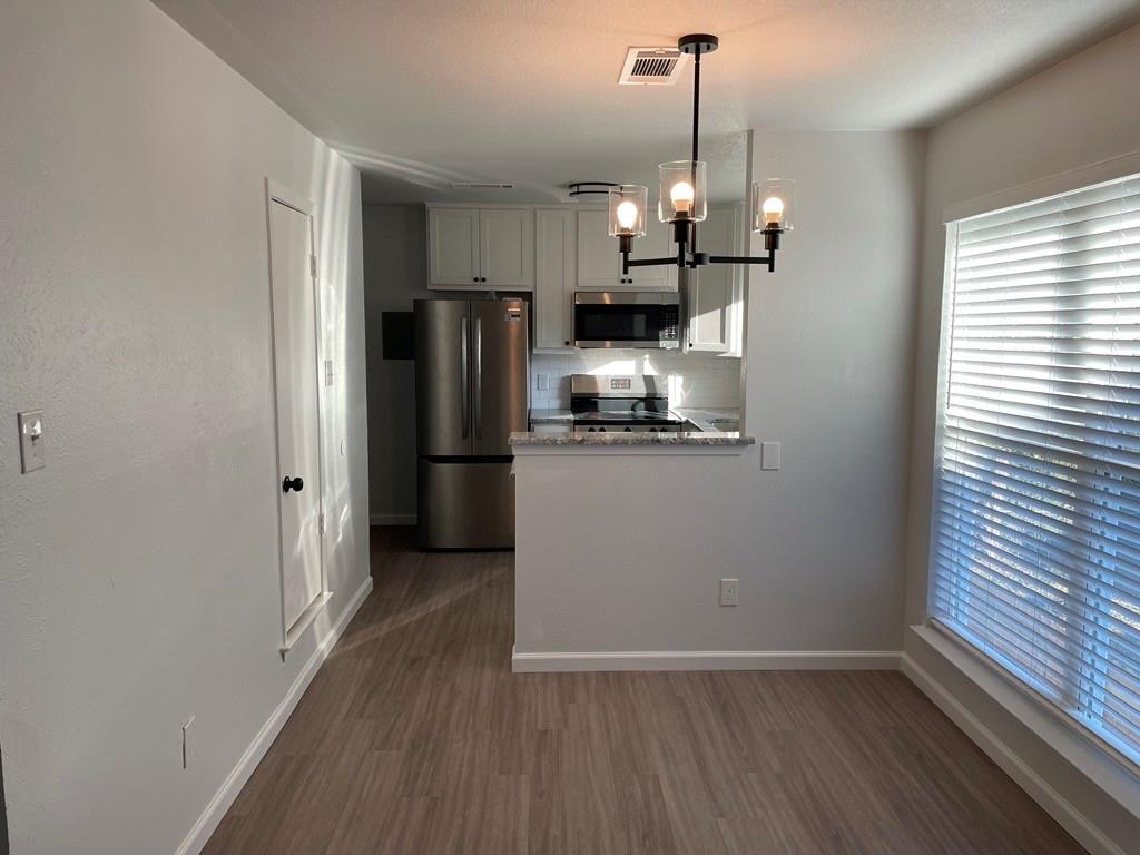705 Gregg Street, Unit 4 Denton, TX 76201 - Photo 1 of 1 Dining room with chandelier