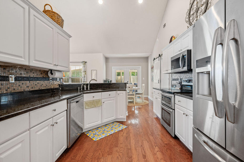 4475 New Market Road Niceville, FL 32578 - Photo 12 of 31 a kitchen with stainless steel appliances granite countertop a refrigerator a stove top oven a sink and dishwasher
