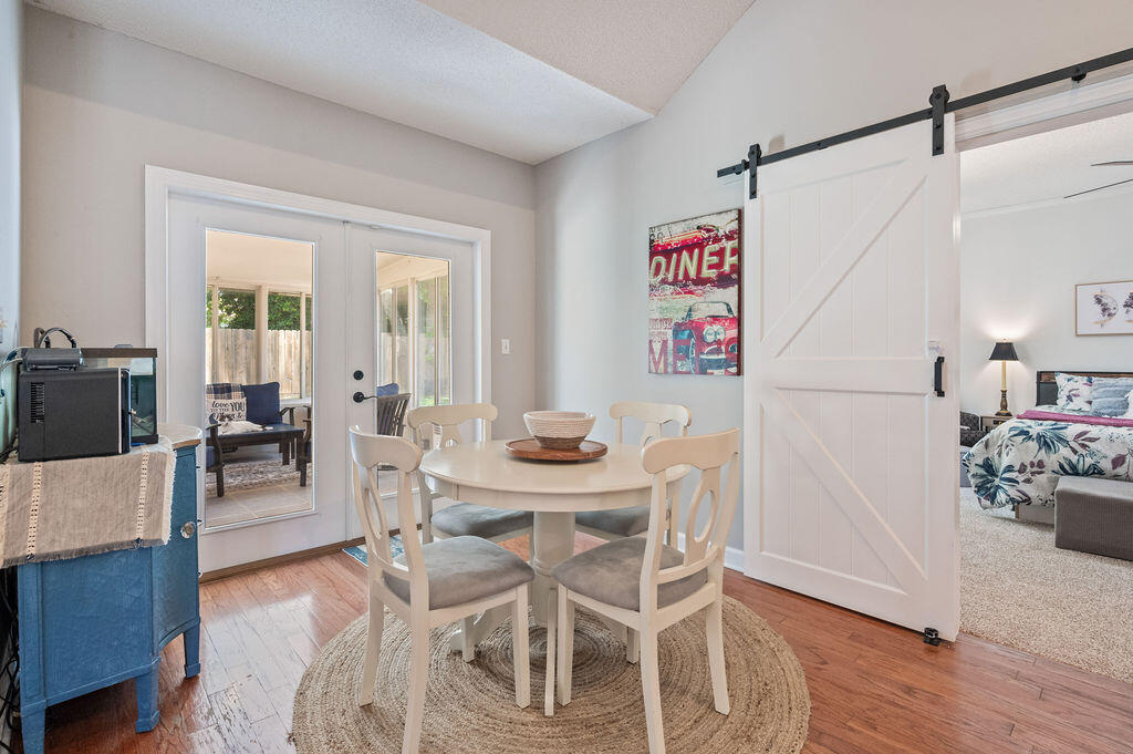 4475 New Market Road Niceville, FL 32578 - Photo 13 of 31 a view of a dining room with furniture and wooden floor