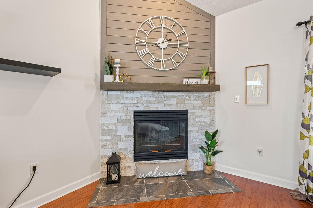 4475 New Market Road Niceville, FL 32578 - Photo 8 of 31 a living room with a fireplace and a wooden floor