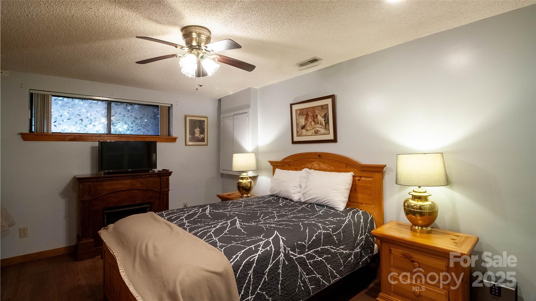 280 Kilgore Road Waynesville, NC 28785 - Photo 30 of 45 a bedroom with a bed and a flat screen tv