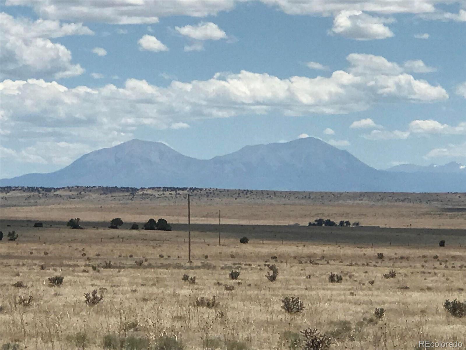 a view of dirt field and mountain