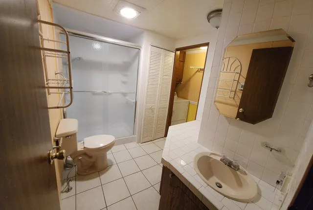a bathroom with a sink toilet and shower