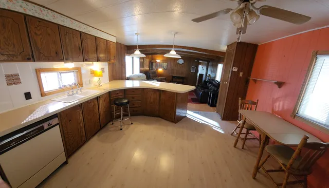 a kitchen with stainless steel appliances wooden cabinets a sink and a stove