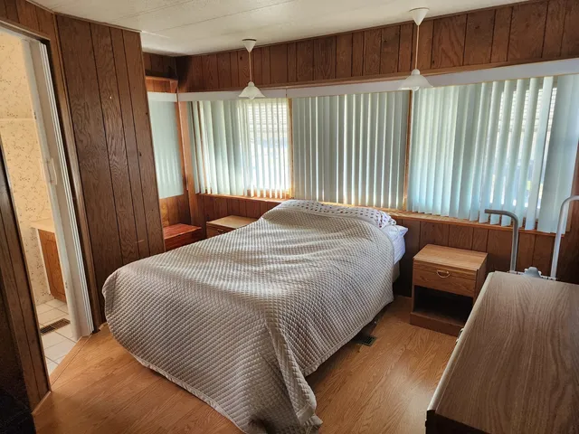 a bedroom with a bed and a mirror