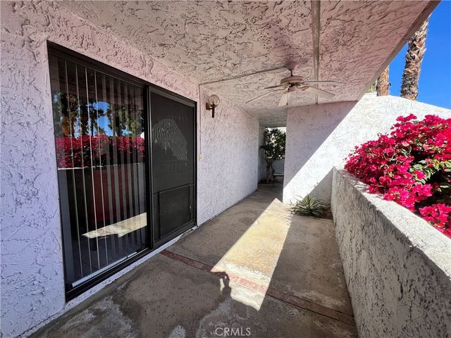 a view of balcony with table and chairs