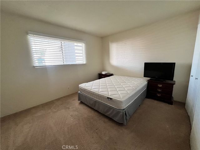 a bedroom with a bed and a night stand