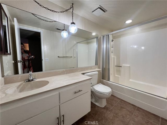 a spacious bedroom with a bed and a couch