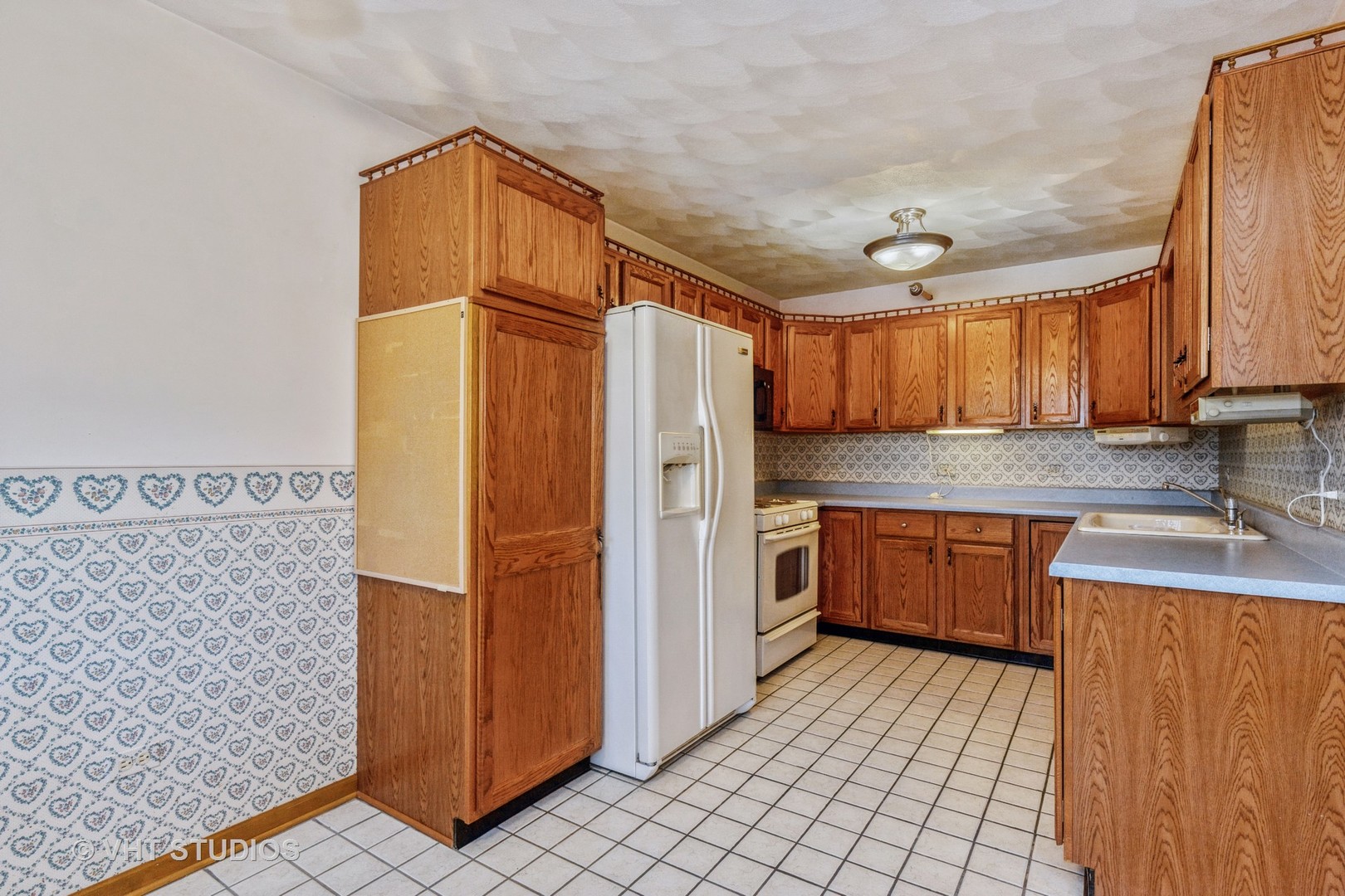 1675 West Beach Road, Unit 1675 Waukegan, IL 60087 - Photo 3 of 12 a kitchen with stainless steel appliances granite countertop a refrigerator and a sink