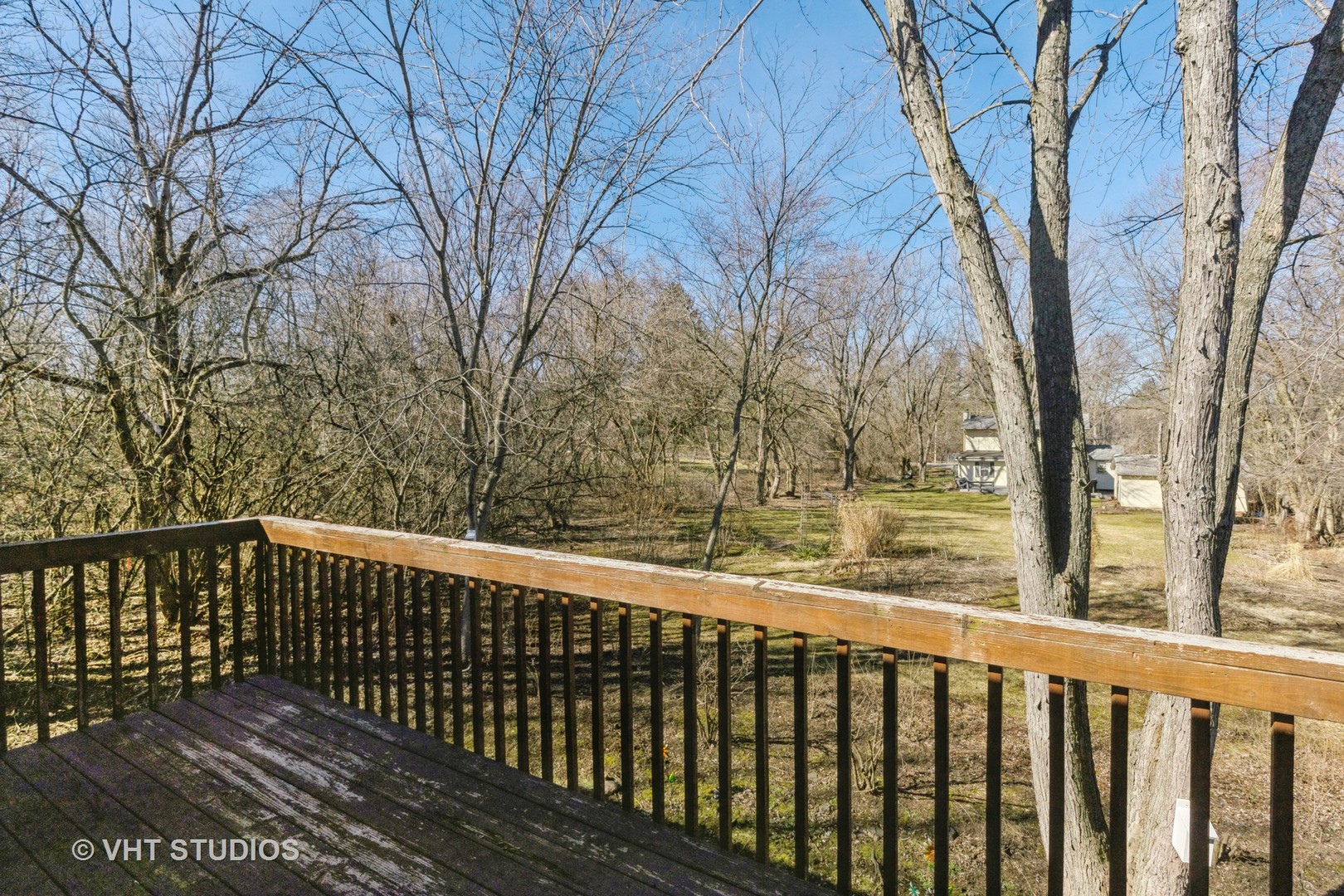 1675 West Beach Road, Unit 1675 Waukegan, IL 60087 - Photo 9 of 12 a view of a wooden roof deck with trees