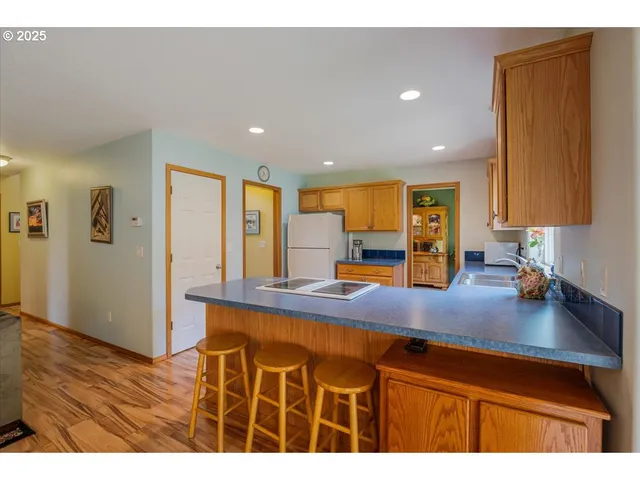 a kitchen with kitchen island a counter top space a sink and cabinets