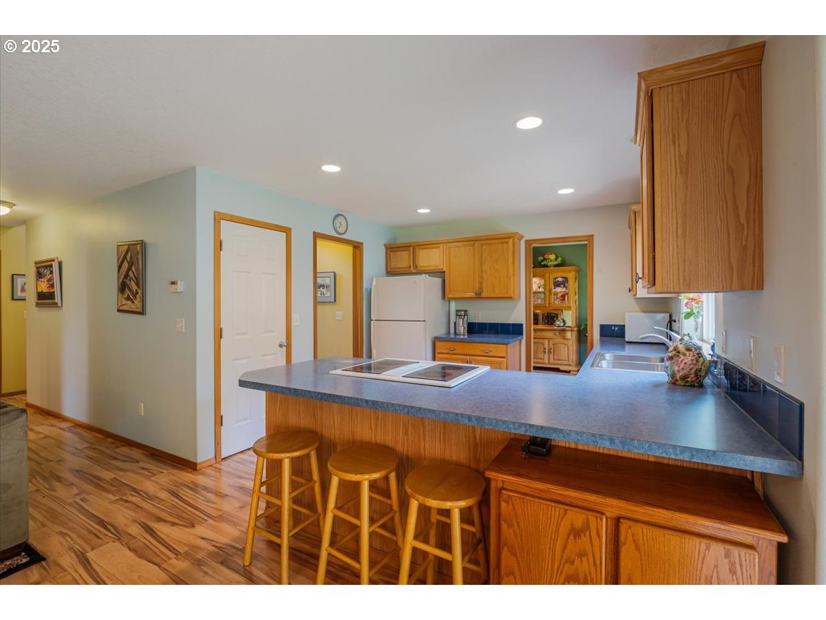 287 Southwest Oliver Court Dundee, OR 97115 - Photo 17 of 41 a kitchen with kitchen island a counter top space a sink and cabinets