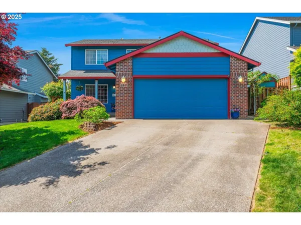 a front view of a house with a yard and garage