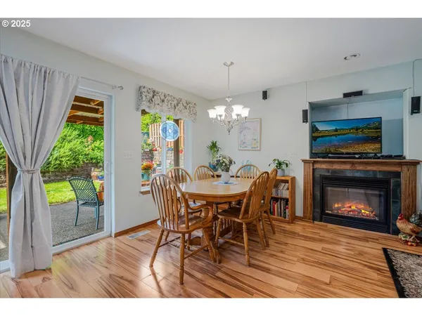 a dining room with furniture a fireplace and a chandelier