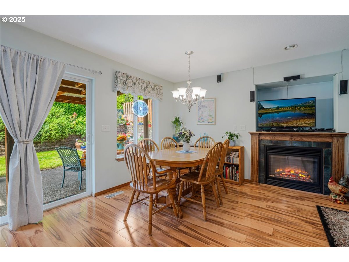 287 Southwest Oliver Court Dundee, OR 97115 - Photo 22 of 41 a dining room with furniture a fireplace and a chandelier