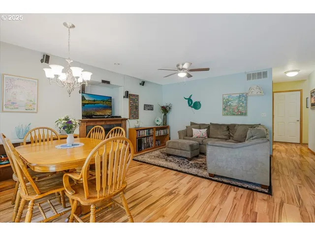 a living room with furniture a dining table and a fireplace