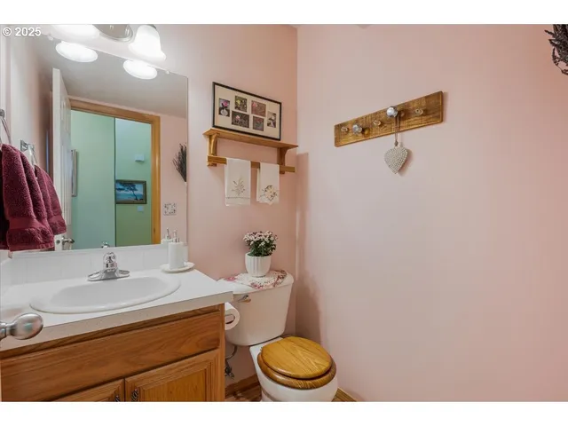 a bathroom with a sink mirror vanity and toilet
