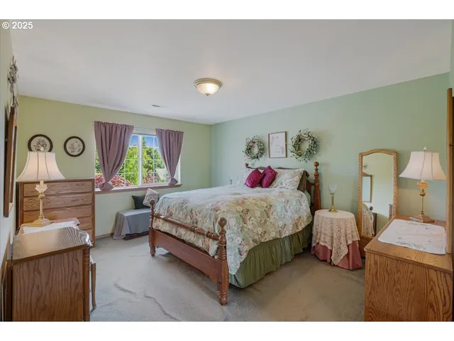 a bedroom with a bed window and dresser