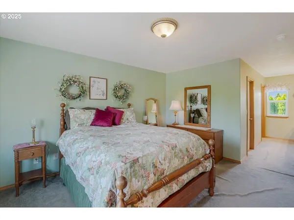 a bedroom with a bed a table and chair