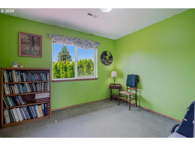 a living room with furniture and a book shelf