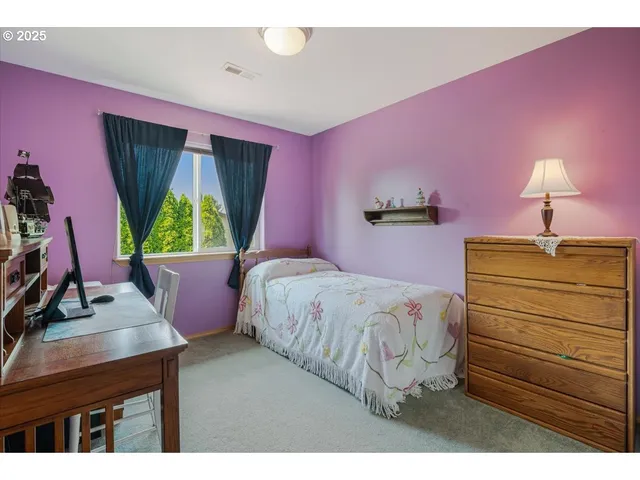 a bed room with a bed and a window