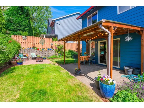 a view of a patio with table and chairs potted plants