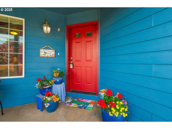 a view of front door of the house with wooden floor