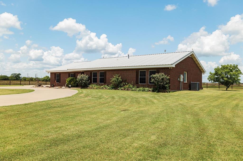 20175 Willow Glade Circle Pilot Point, TX 76258 - Photo 27 of 32 View of front of house featuring central air condition unit and a front lawn