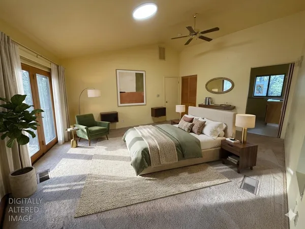 a view of a livingroom with a refrigerator and a ceiling fan