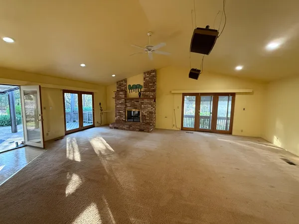 a view of a livingroom with a ceiling fan and window