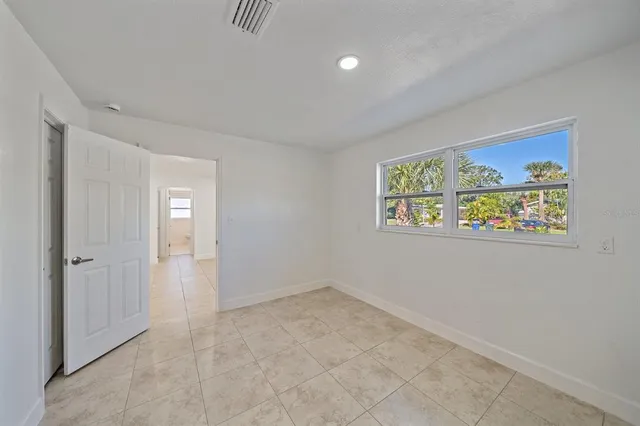 an empty room with painting on the wall