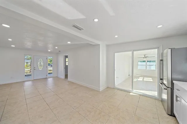 a view of an empty room and a window